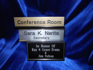 Three nameplates on display